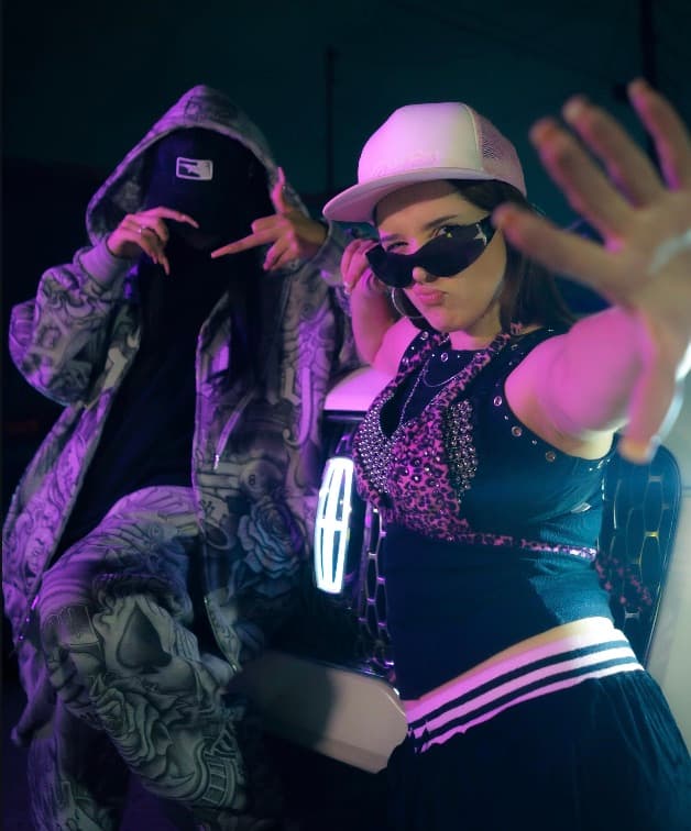 hacko in star sunglasses under purple light
